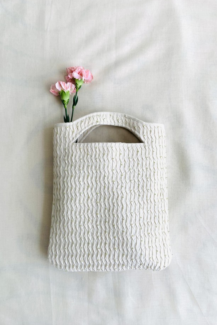 White handloom cotton smocked beaded bag